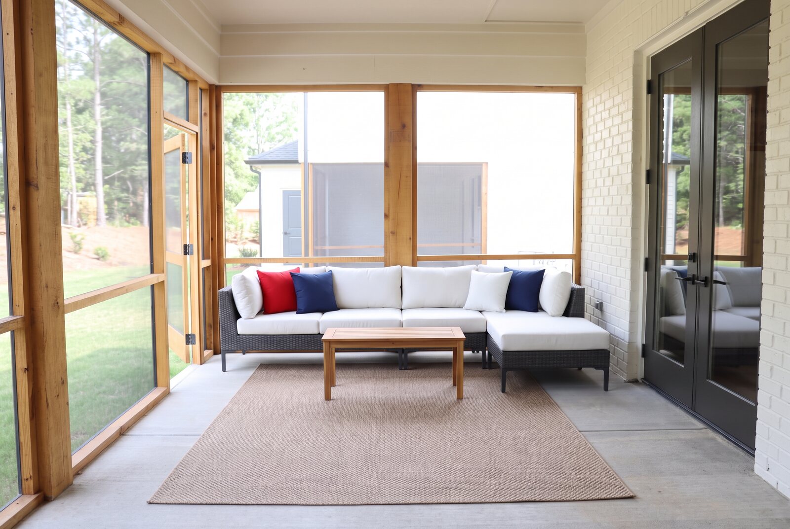 Private screened patio with modular seating, television and lawn views
